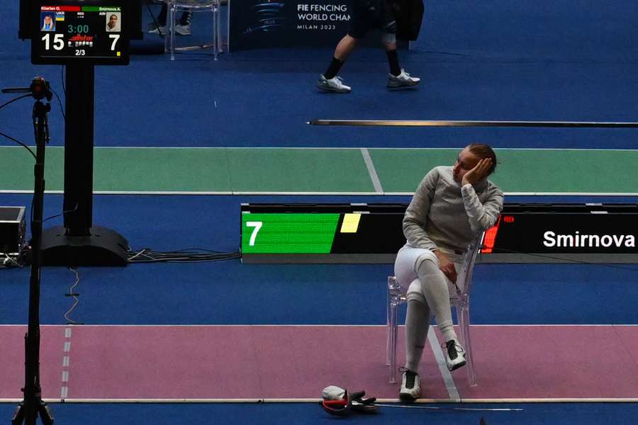 Russia's Anna Smirnova, registered as an Individual Neutral Athlete (AIN), sits on the fencing strip in protest, after Ukraine's Olha Kharlan (not in picture) refused to shake hands with her