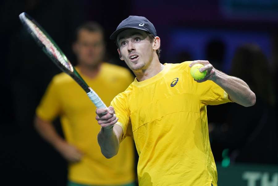Australia's Alex de Minaur hits balls into the crowd after his win