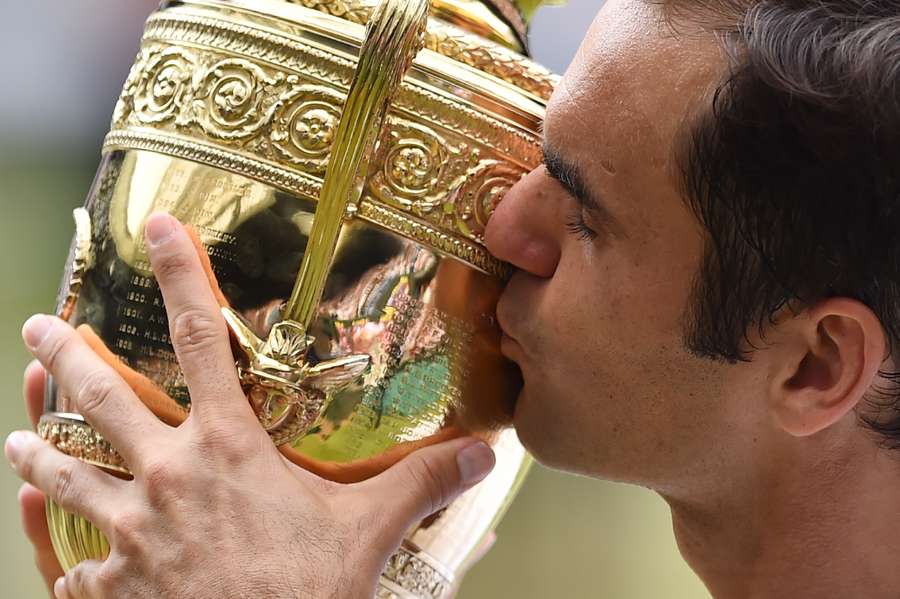 Roger Federer kisses the Wimbledon trophy after beating Marin Cilic in the men's singles final in 2017.