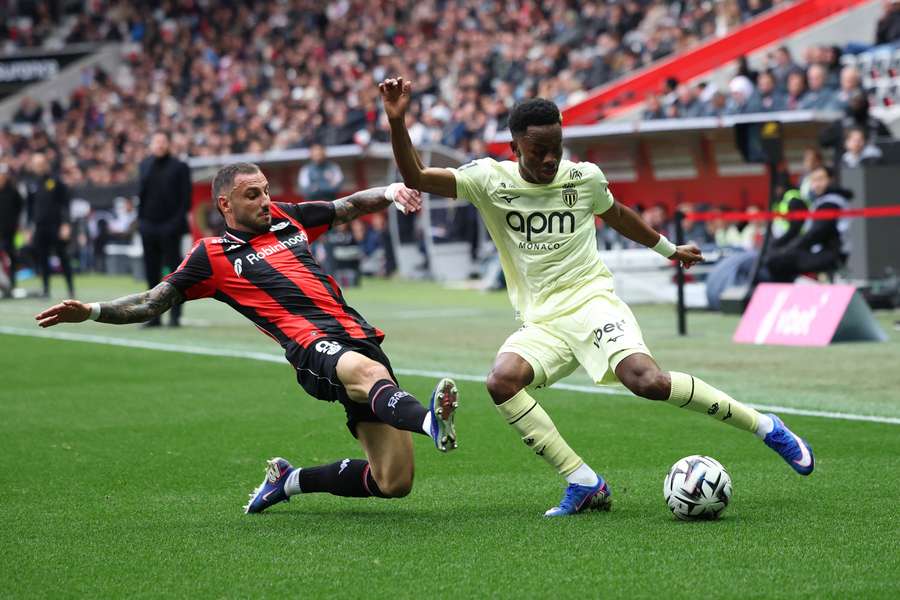 Nice's Jonathan Clauss fights for the ball with Monaco's Simon Adingra