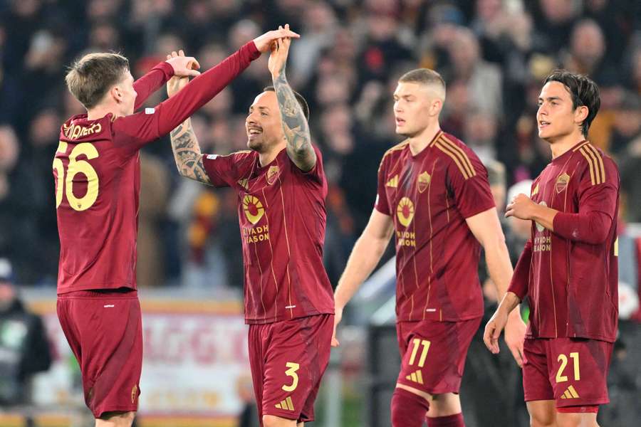Jose Tasende celebrates with teammates after opening the scoring for Roma