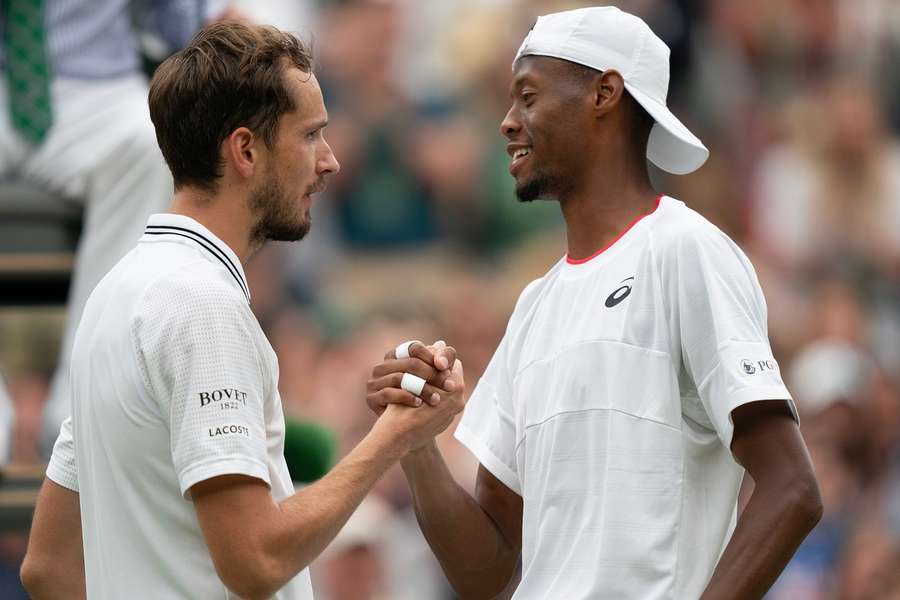 Medvedev and Eubanks meet at the net after a thrilling contest