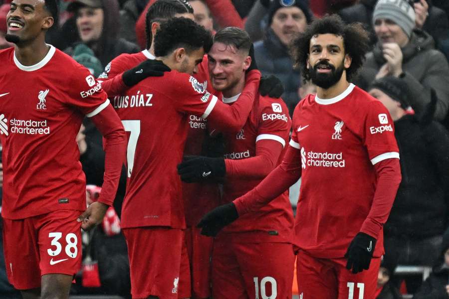 Liverpool's Argentinian midfielder #10 Alexis Mac Allister (2R) celebrates with teammates after scoring their second goal