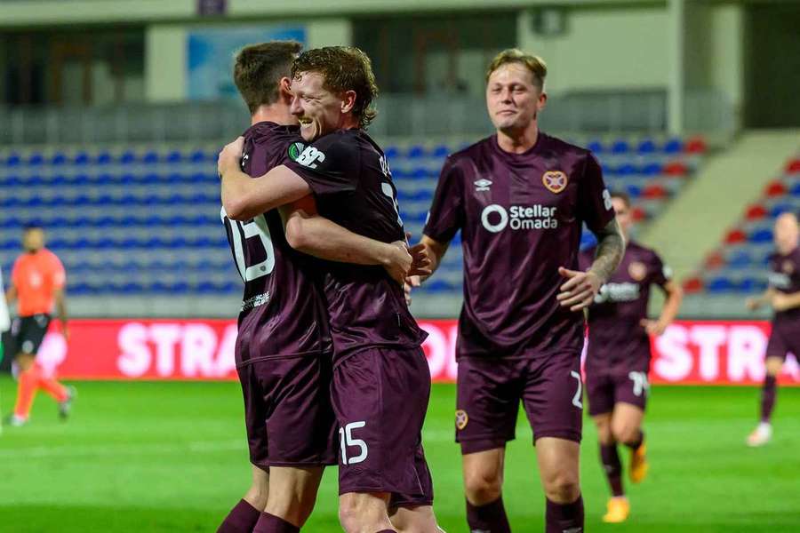 Kye Rowles celebrates with teammates after scoring the equalising goal for Hearts