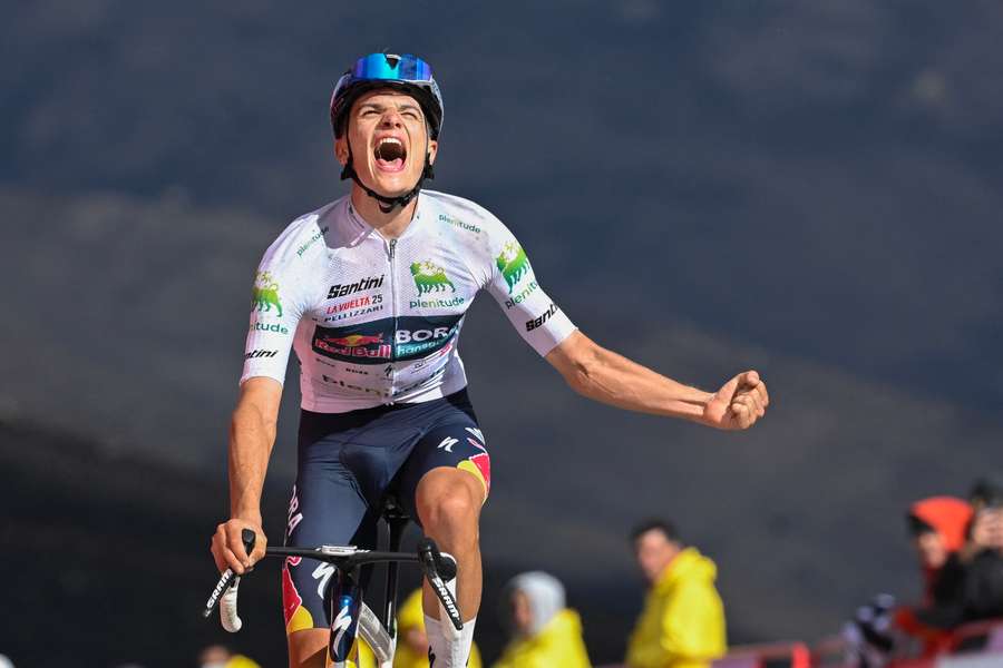 Giulio Pellizzari celebrates as he crosses the finish line to win the 17th stage of the Vuelta a Espana