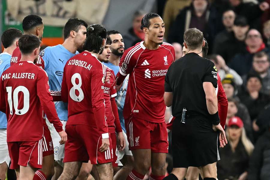 Van Dijk (centre) appeals to the referee in last season's fixture Van Dijk (centre) appeals to the referee in last season's fixture