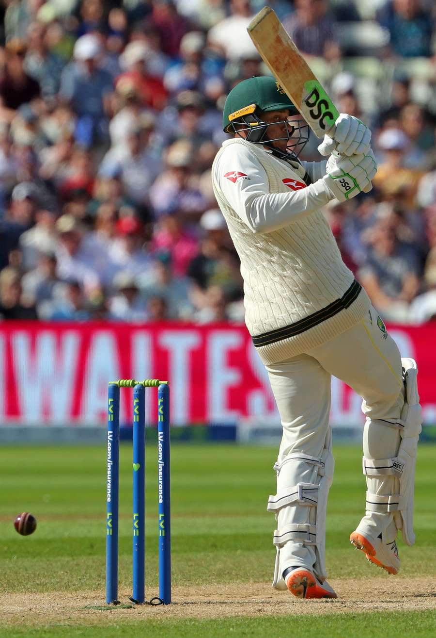 Australia's Usman Khawaja hits a boundary in the first over of their second innings on day four