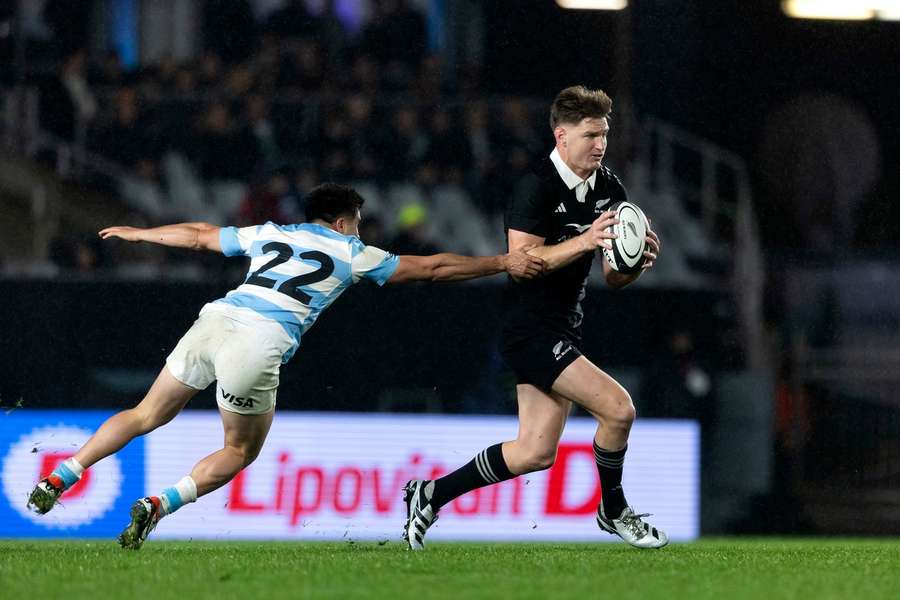 Tomas Albornoz, left, reacts to attempt a tackle on New Zealand's Jordie Barrett 