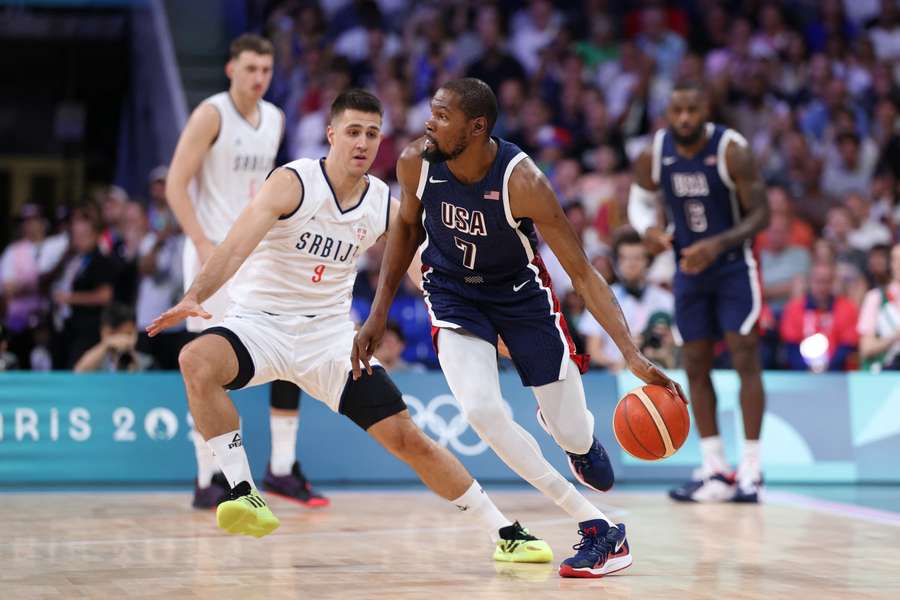 Kevin Durant #7 of Team United States drives to the basket against Vanja Marinkovic #9 of Team Serbia 