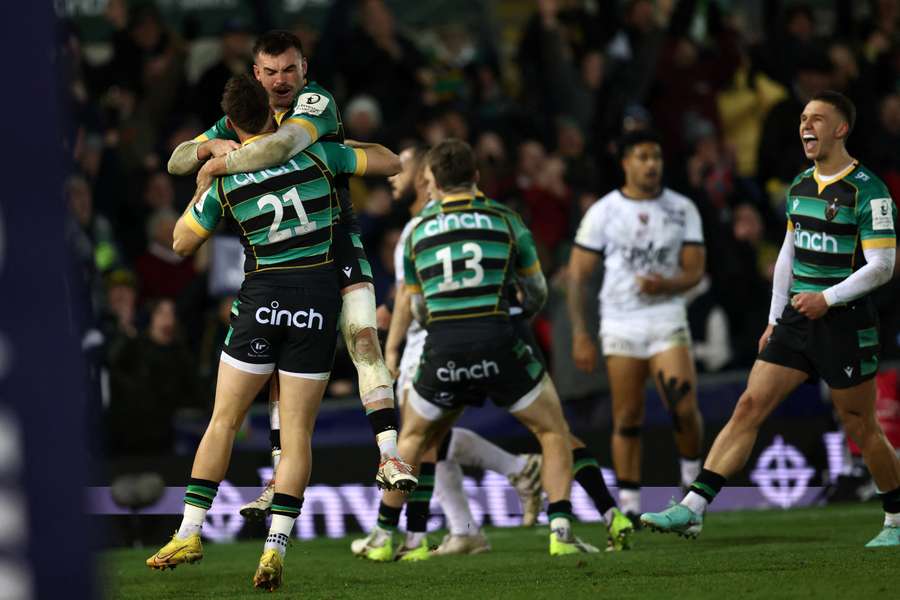 Northampton players celebrate on the final whistle 