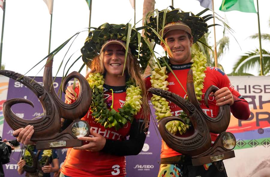 Australian surfer Jack Robinson and US surfer Caroline Marks celebrate their respective victories in the men's and women's finals of the Tahiti World Surf League at Teahupo'o in Tahiti