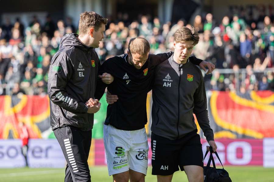 Gustav Lundgren helped off the pitch during the warm-up