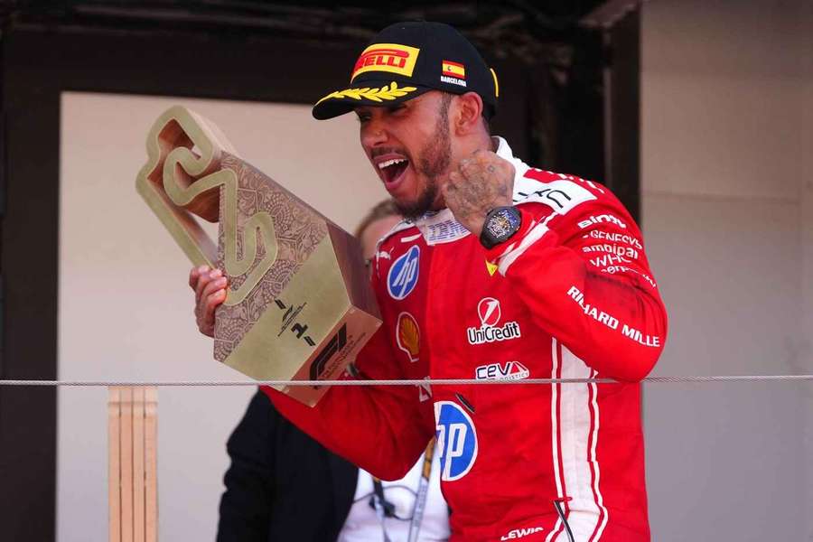 Lewis Hamilton celebrates with the trophy on the podium after winning the Barcelona GP Lewis Hamilton celebrates with the trophy on the podium after winning the Barcelona GP