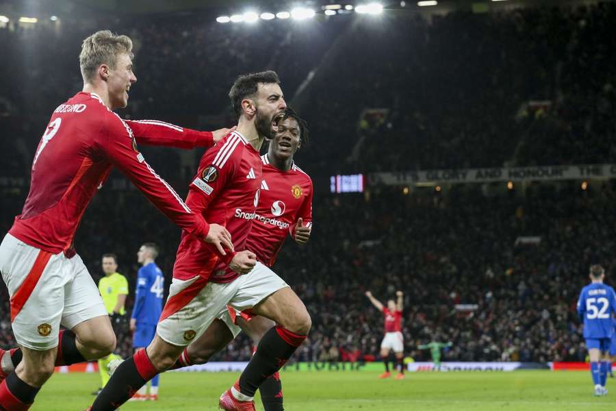 Manchester United midfielder Bruno Fernandes celebrates with Rasmus Hojlund after scoring against Rangers in the Europa League.