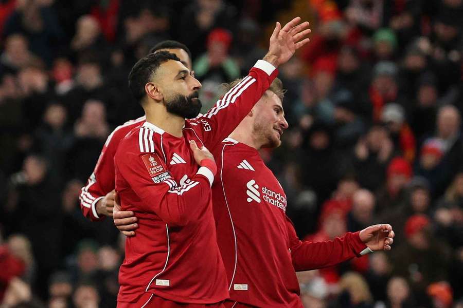 Liverpool's Mohamed Salah celebrates scoring their third goal with Alexis Mac Allister