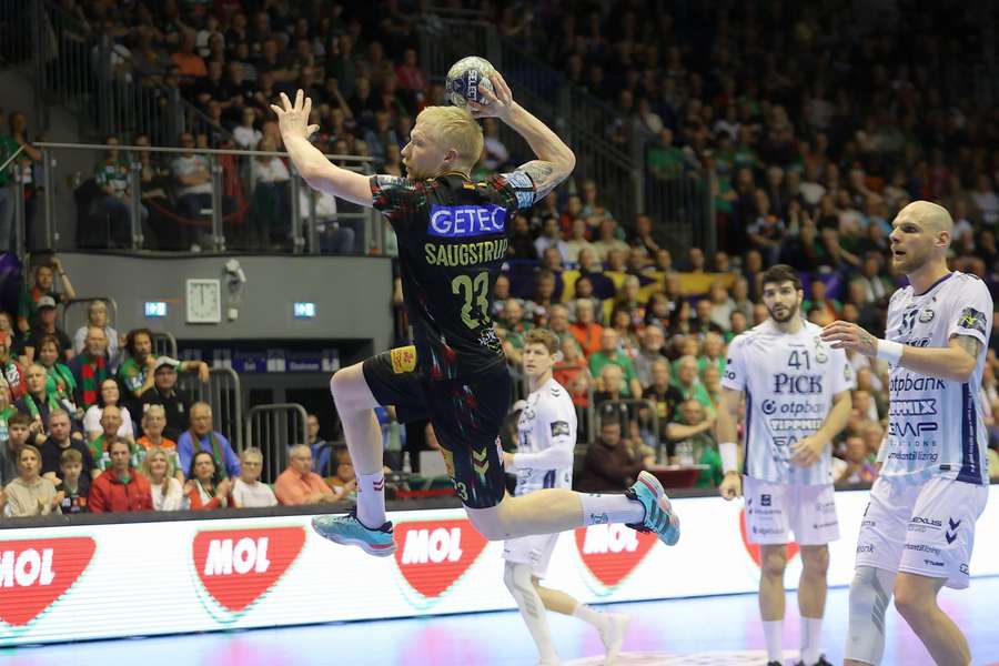 Magnus Saugstrup scores for Magdeburg against Pick Szeged.