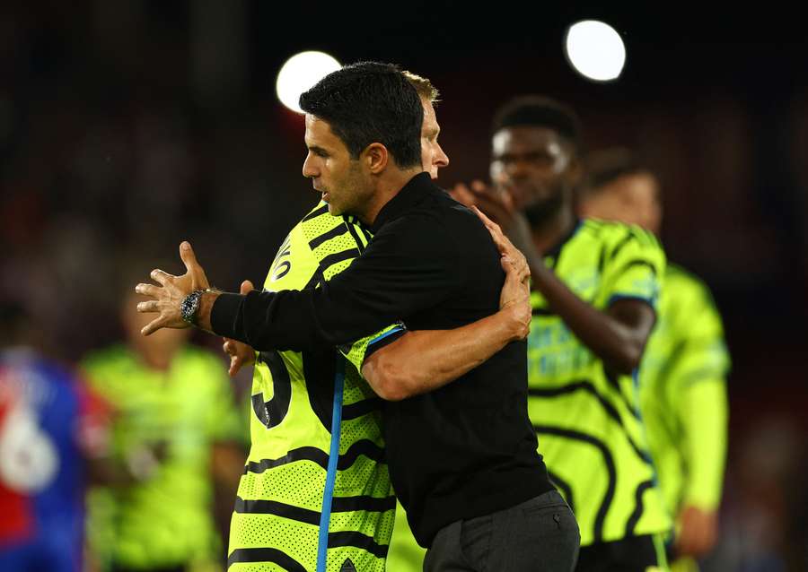 Mikel Arteta embraces Martin Odegaard after their tight victory