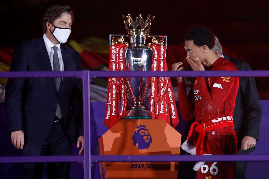 Liverpool's English defender Trent Alexander-Arnold (R) receives his Premier League winner medal in 2022