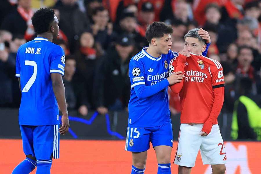Gianluca Prestianni hides his mouth while arguing with Real Madrid's Vinicius Junior