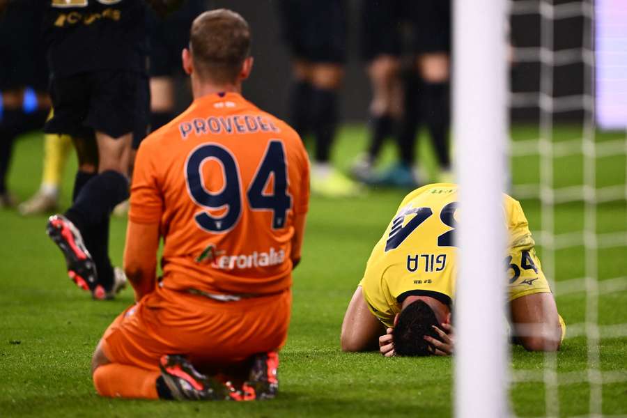 Gila (R) reacts after his own goal