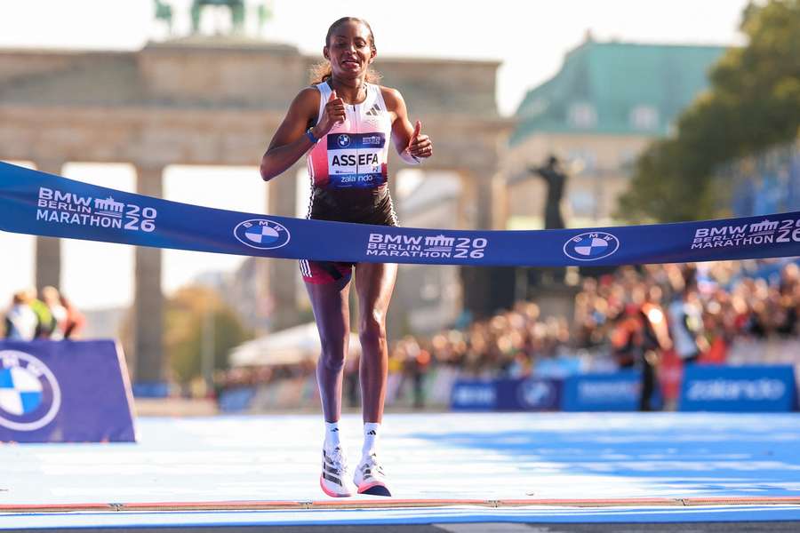 Tigst Assefa celebrates crossing the line and winning the Berlin Marathon Tigst Assefa celebrates crossing the line and winning the Berlin Marathon