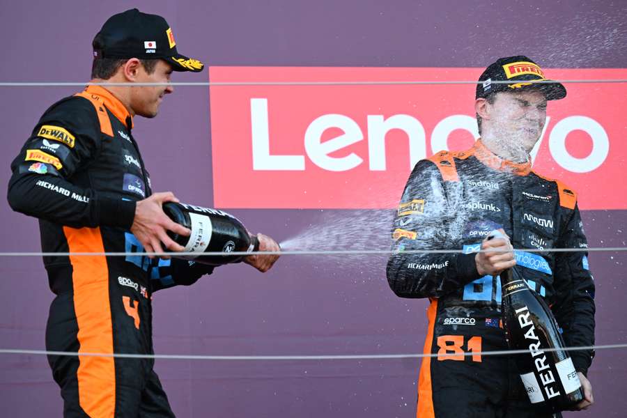 McLaren's Lando Norris (L) and Oscar Piastri celebrate on the podium