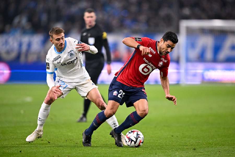 Valentin RONGIER and Benjamin ANDRE battle for the ball