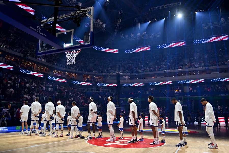 The US team line up before the game during the national anthems