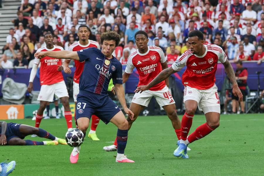 PSG's Joao Neves fights off the close attention of Arsenal centre-back Gabriel Arsenal PSG's Joao Neves fights off the close attention of Arsenal centre-back Gabriel Arsenal
