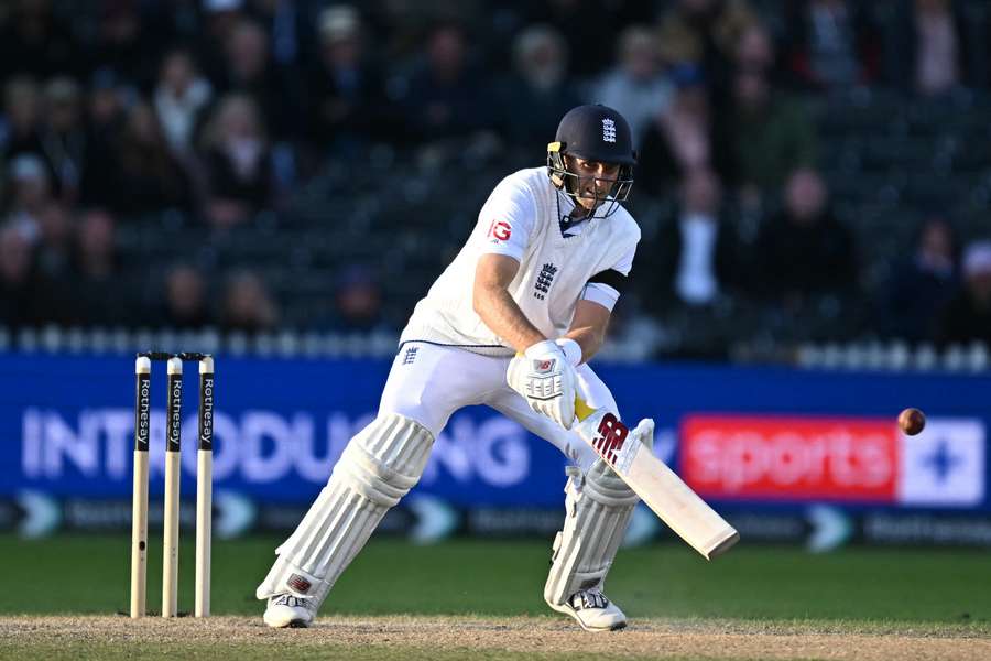 England's Joe Root attempts a scoop shot on day four of the first Test cricket match between England and Sri Lanka