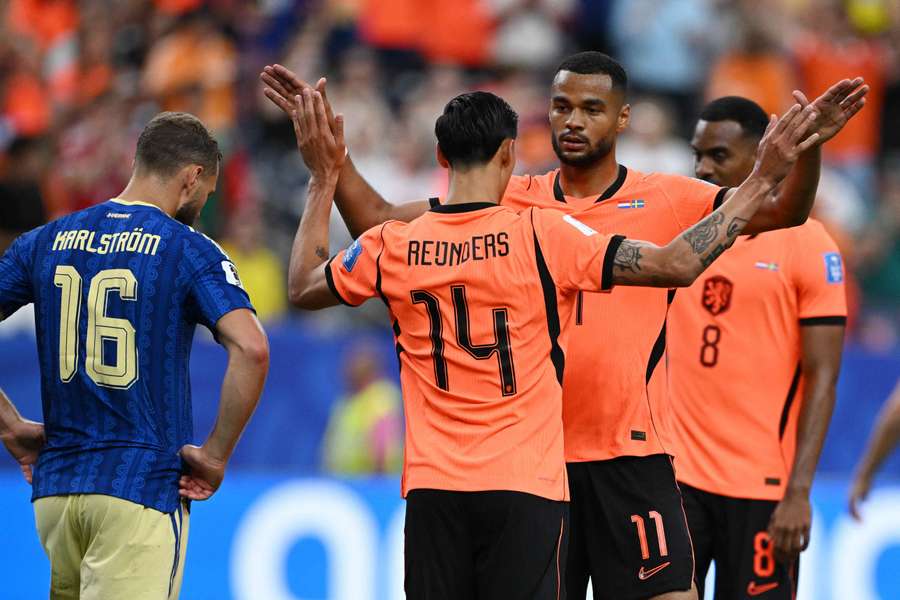 Cody Gakpo celebrates scoring the Netherlands' fourth goal with Tijjani Reijnders.