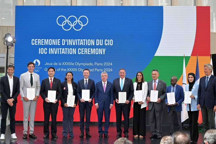 Members of the IOC gather to mark one year until the start of the Paris Olympics