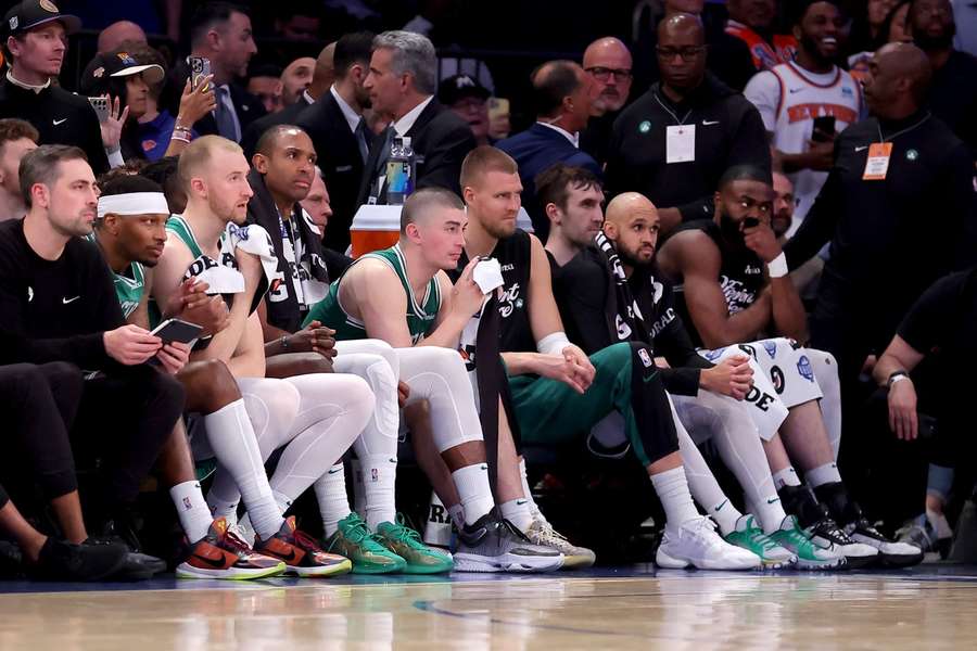 The Celtics players sit disappointed during their Game 6 thrashing