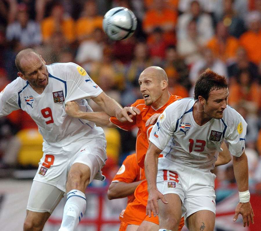Stam (centre) battles for the ball with Koller