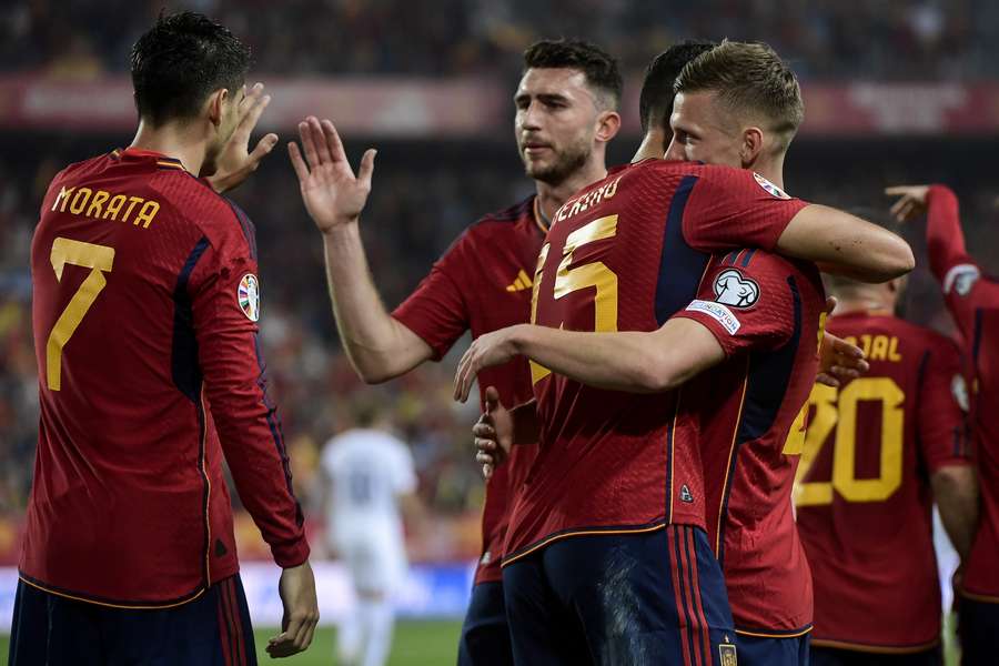 Dani Olmo celebrates with teammates after scoring Spain's first goal