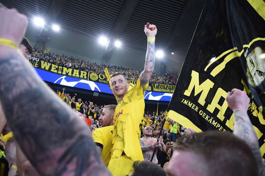 Marco Reus celebrating with the travelling Dortmund support