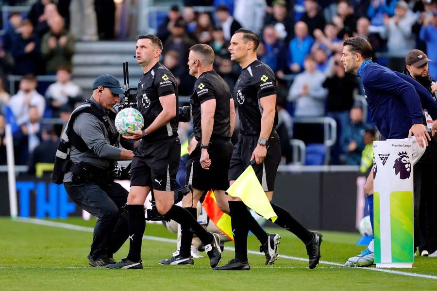 Referee Michael Oliver leads out his assistant referees before the Everton vs Manchester City game