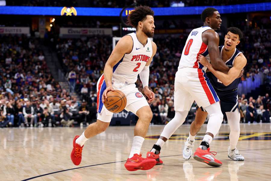 Cade Cunningham handles the ball against the Denver Nuggets