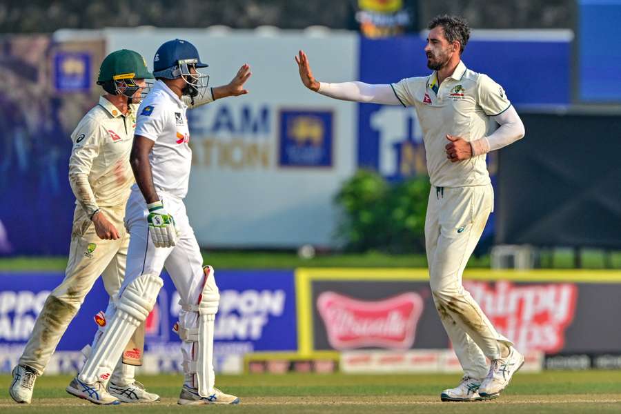 Australia's Mitchell Starc (right) celebrates after taking the wicket of Sri Lanka's Prabath Jayasuriya on the first day of the second Test