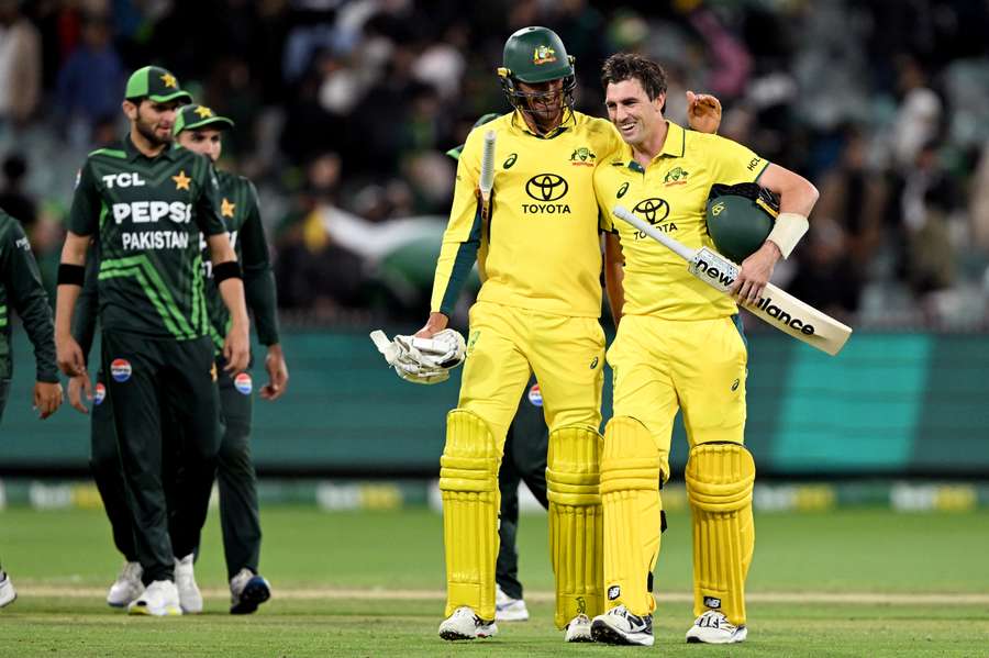 Australian batsman Pat Cummins (R) is congratulated by teammate Mitchell Starc after hitting the winning run