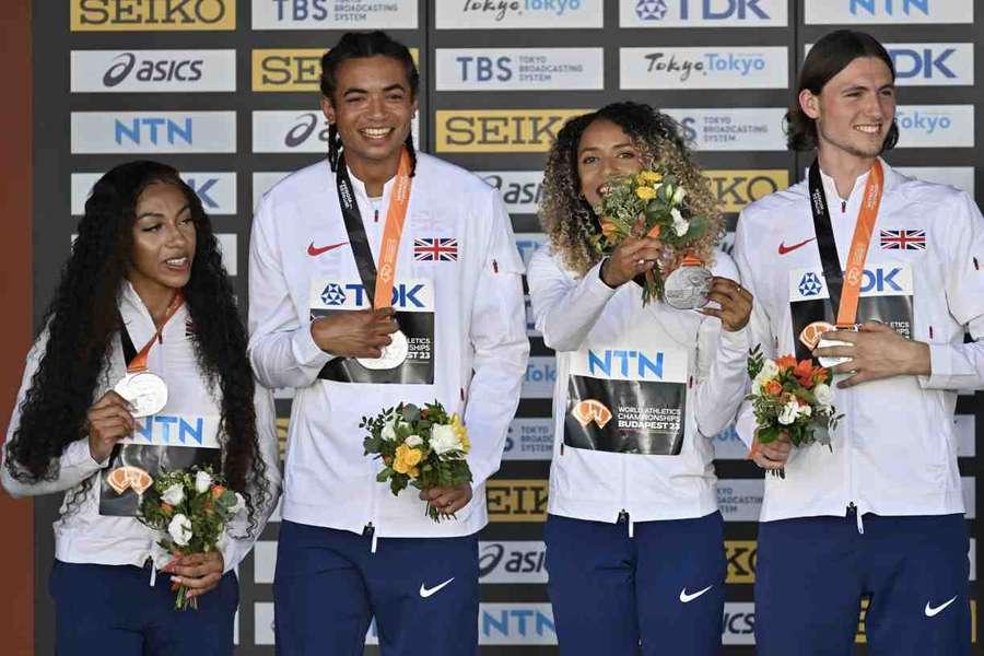 Britain's silver medallists Yemi Mary John, Rio Mitcham, Laviai Nielsen, and Lewis Davey celebrate during the podium ceremony for the mixed 4x400m relay