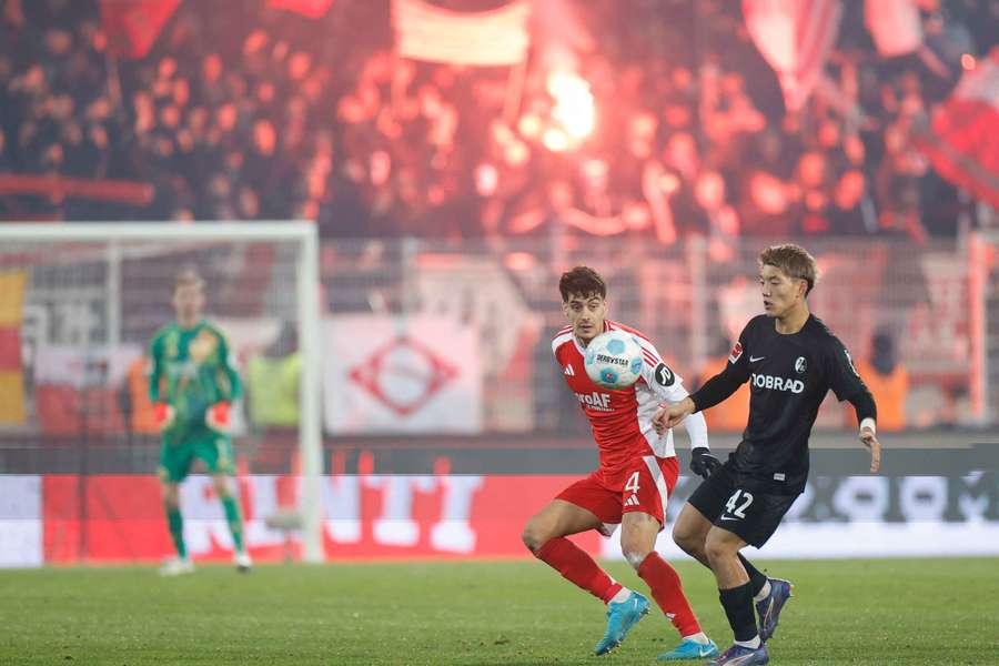 Freiburg's Japanese forward Ritsu Doan and Union Berlin's Diogo Leite vie for the ball 