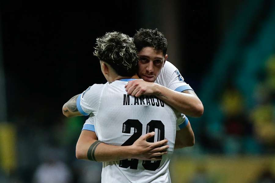 Uruguay players breathe a sigh of relief as they solidify their second-place spot in qualifiers. 