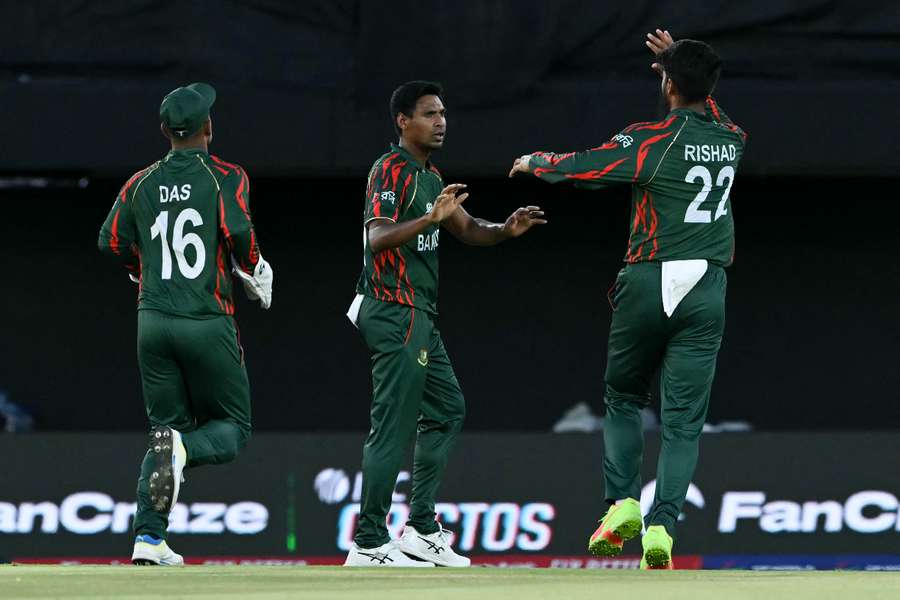 Bangladesh's Litton Das (L), Mustafizur Rahman (C) and Rishad Hossain (R) celebrate after the dismissal of Sri Lanka's Pathum Nissanka