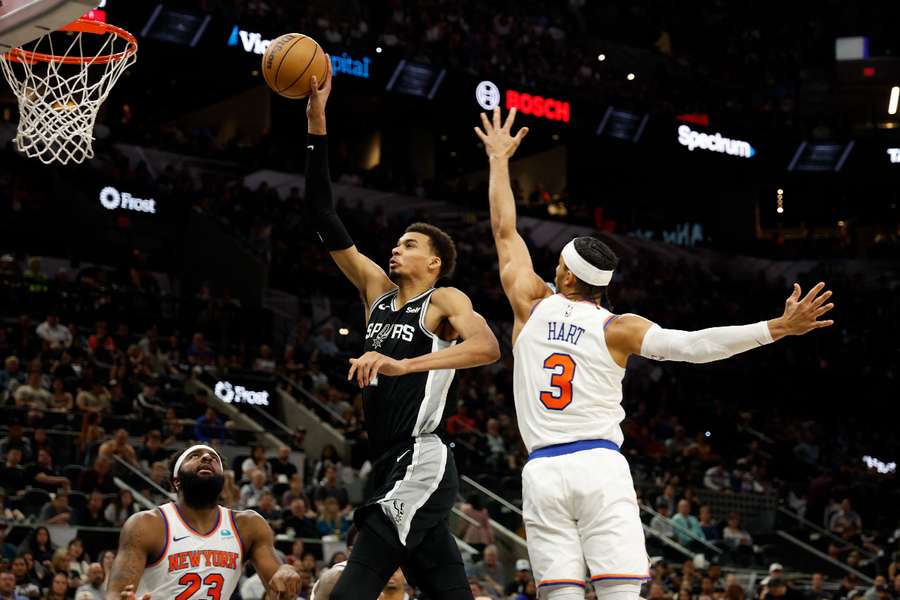 San Antonio rookie Victor Wembanyama drives past New York's Josh Hart in the Spurs' NBA overtime victory over the Knicks