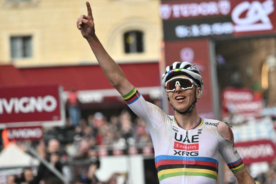 Tadej Pogacar celebrates after winning the 19th one-day classic 'Strade Bianche' on Saturday