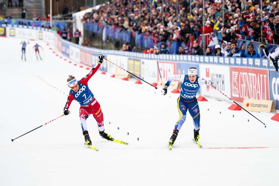 Ebba Andersson (right) takes the win from Therese Johaug in the women's 20km skiathlon 