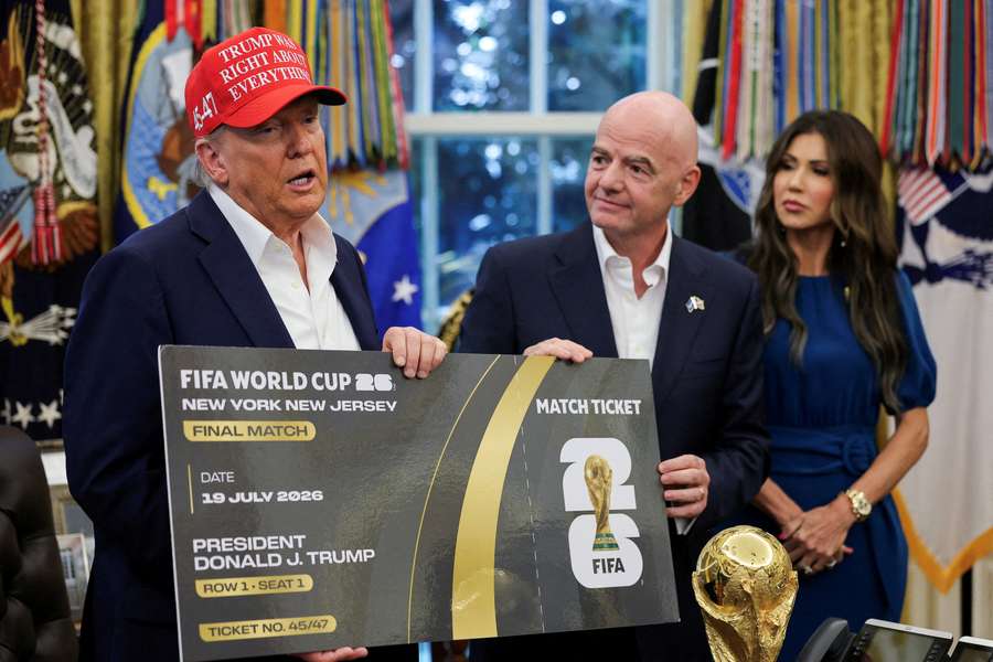 US President Donald Trump and FIFA President Gianni Infantino hold a 2026 FIFA World Cup final ticket in the Oval Office, in Washington, DC 