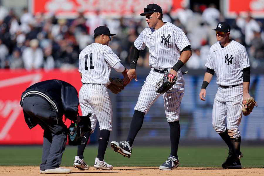 New York Yankees shortstop Anthony Volpe (11) celebrates with centre fielder Aaron Judge (99)