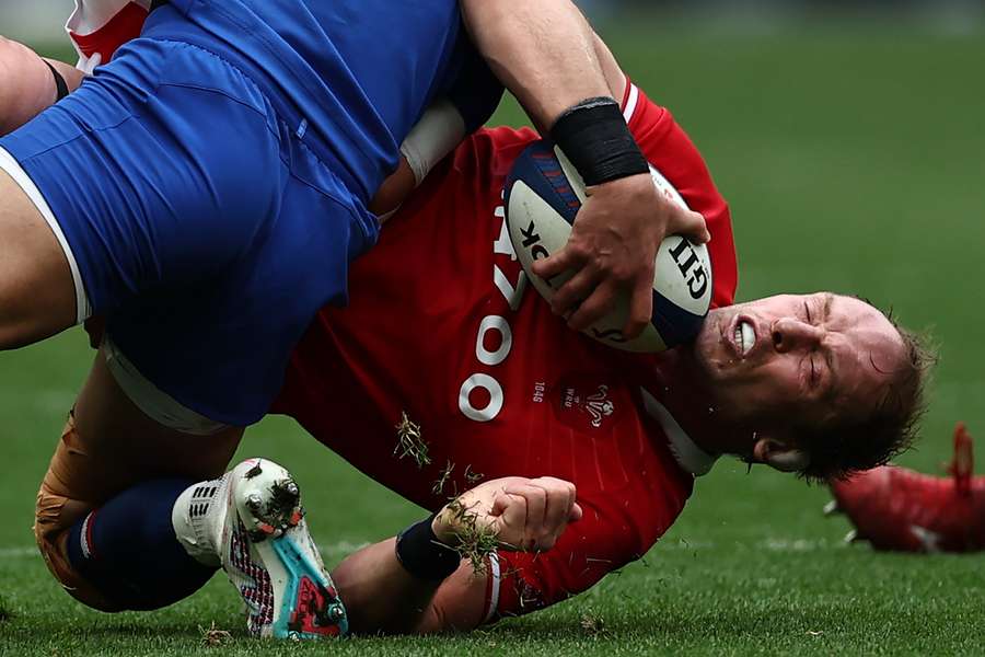 In this file photo taken on March 18, 2023 Wales' lock Alun Wyn Jones (R) is tackled during the Six Nations rugby union international match between France and Wales